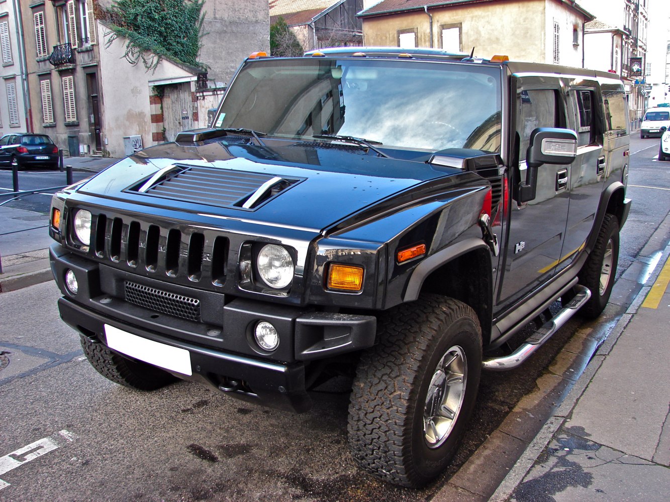 Front and side view of black rugged SUV with distinctive grille