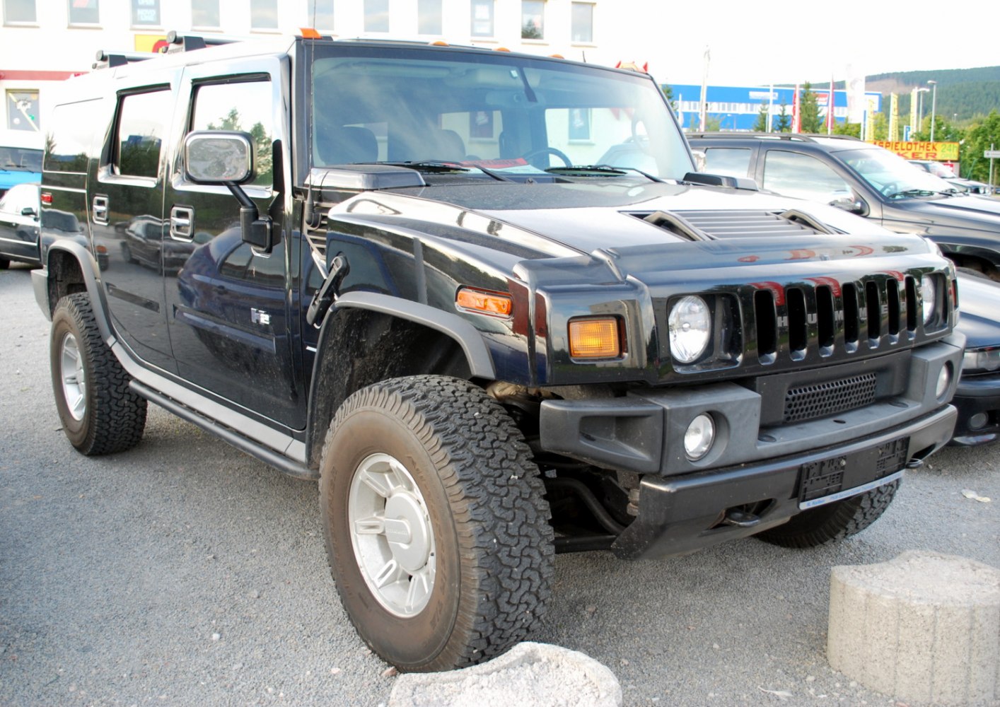 Black SUV with rugged front grille and large off-road tires