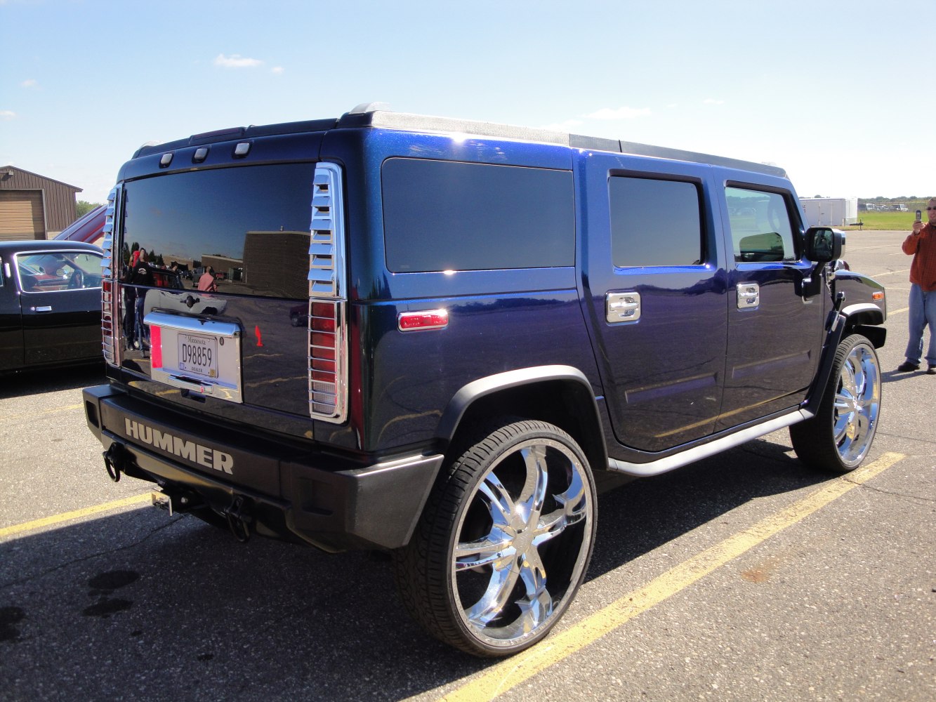 Dark blue SUV with oversized chrome rims and tinted windows