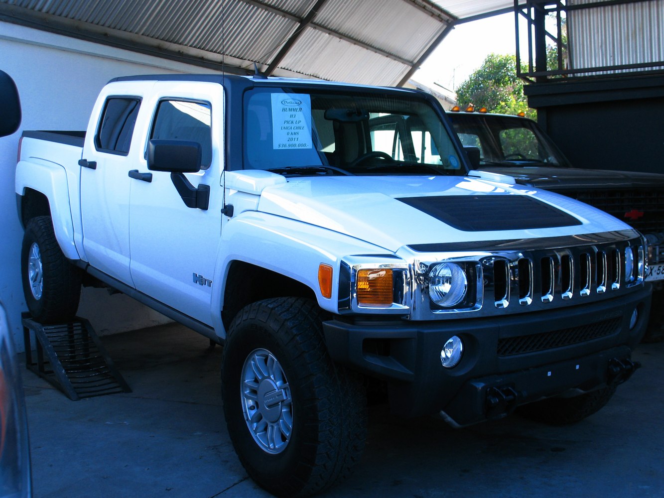 Pickup truck front view with distinctive grille and off-road tires