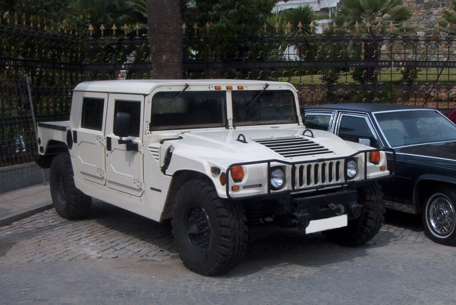 White off-road SUV with grille guard and large tires