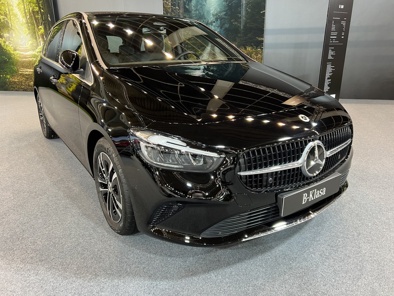 Glossy black front grille and LED headlights of compact hatchback
