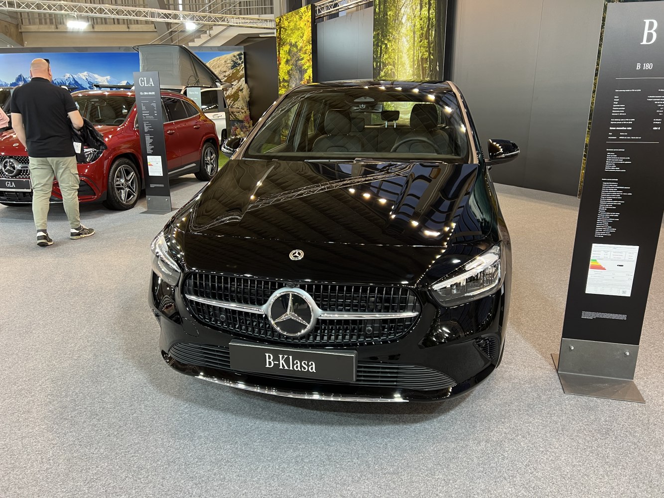 Front view of a black compact luxury hatchback with signature grille and sleek LED headlights