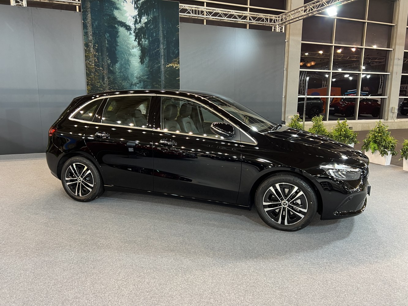 Black compact hatchback with modern alloy wheels and LED headlights