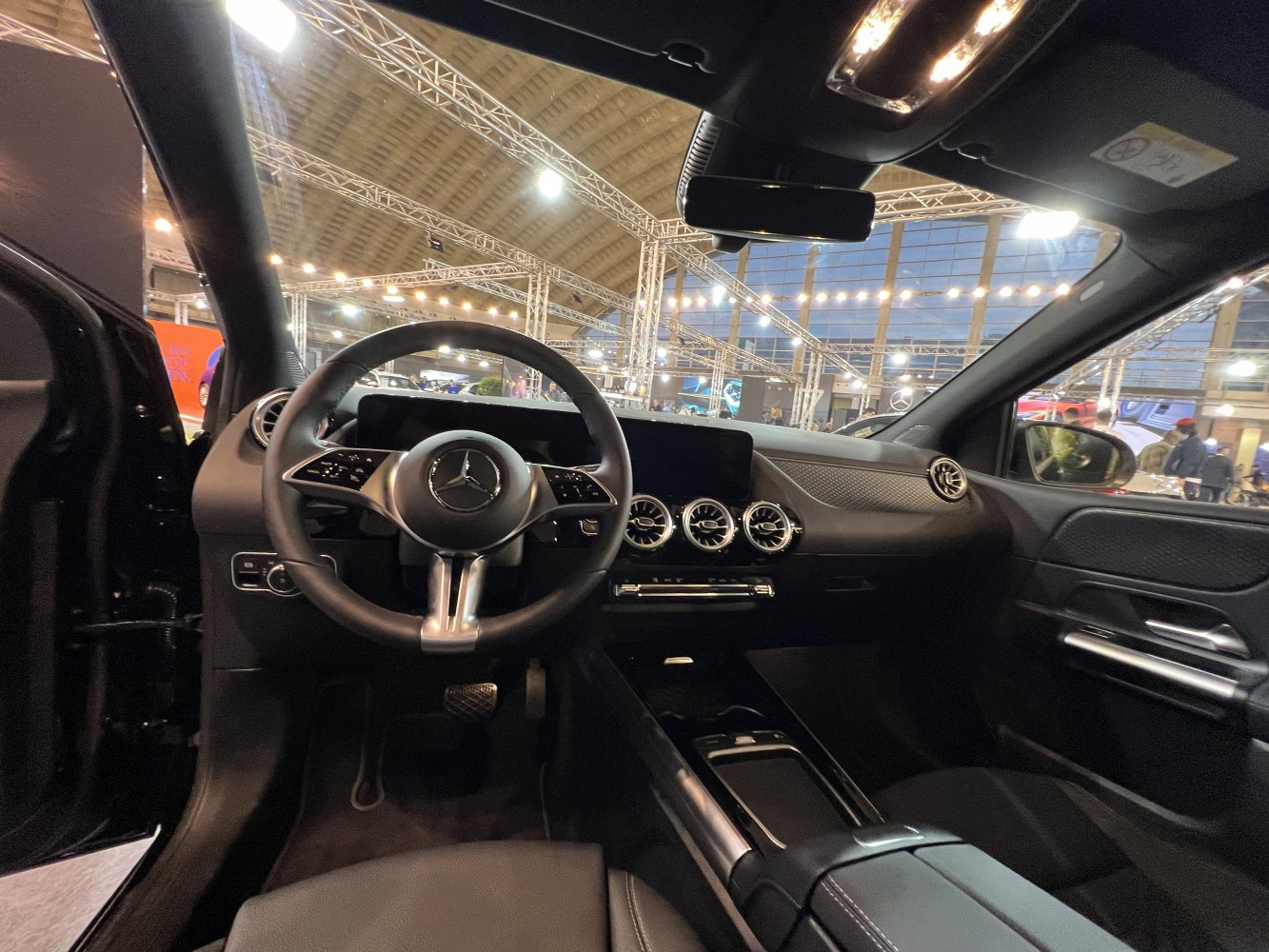 Digital dashboard and three circular air vents in sleek car interior