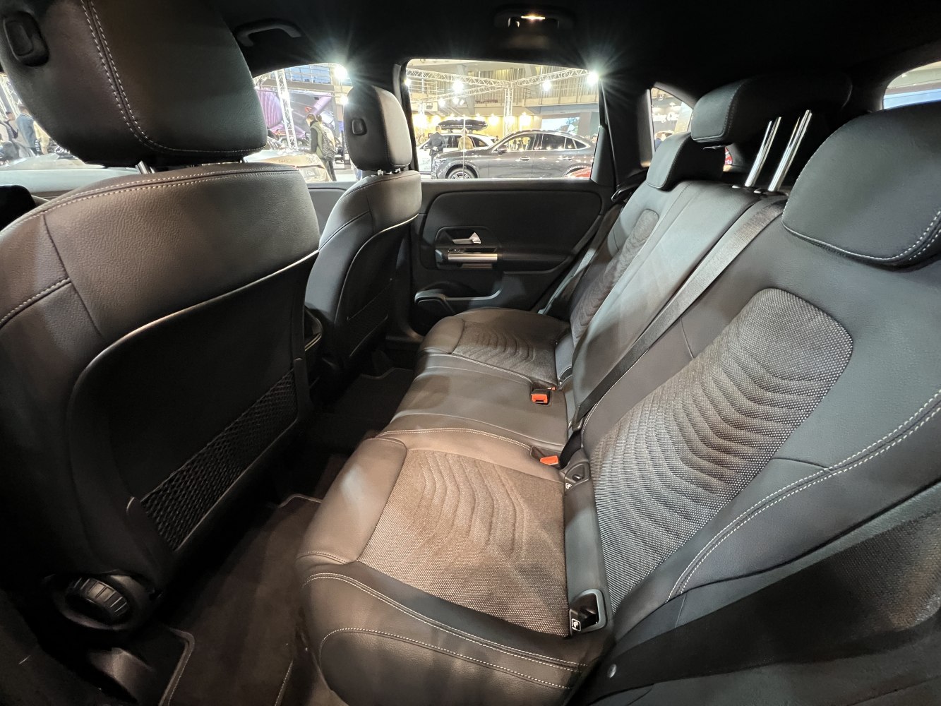 Black leather and fabric rear seats with modern stitching and headrests