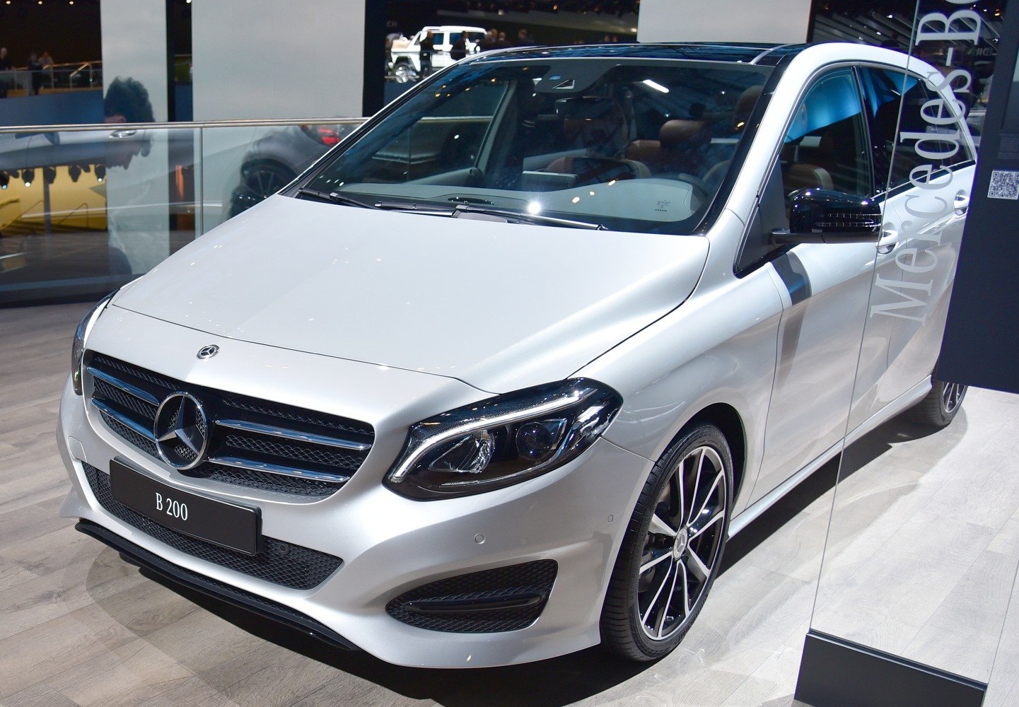 Front and side view with sleek headlights and alloy wheels