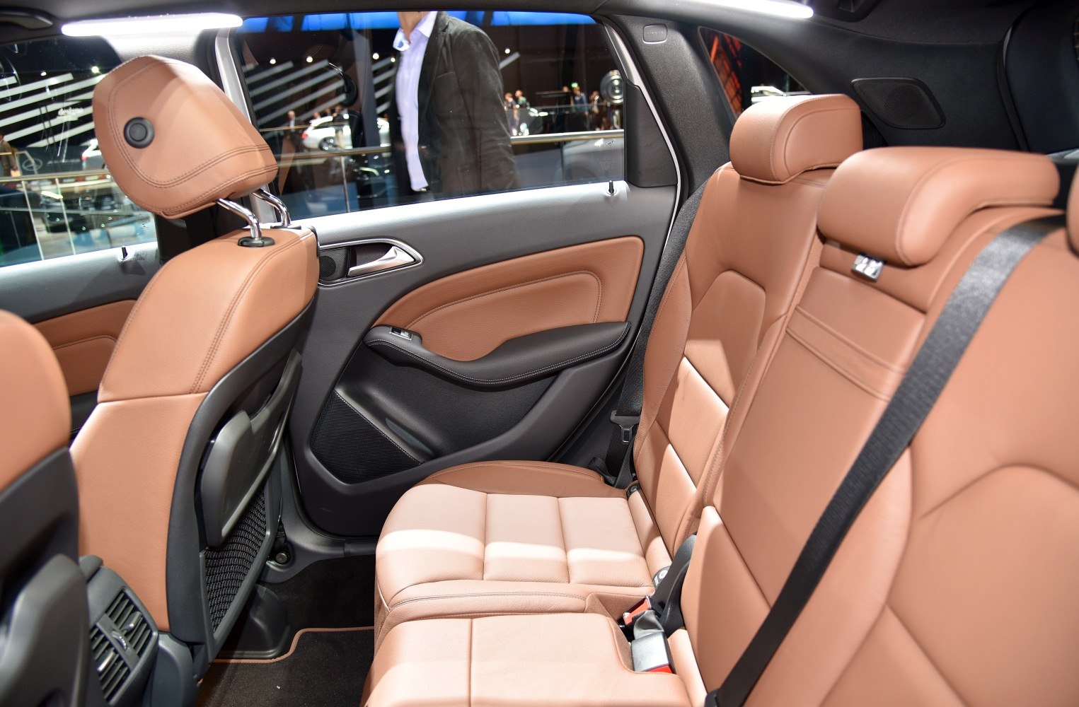 Rear leather seats and door panel with seat belt and premium upholstery.