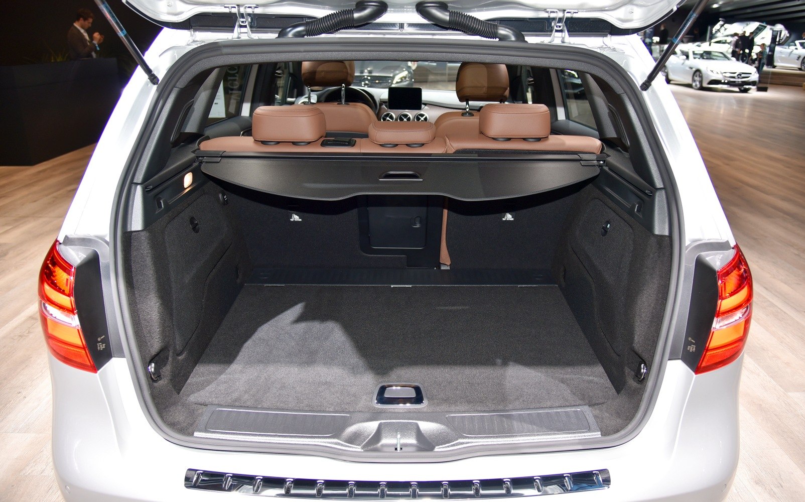 Spacious rear cargo area with protective cover and brown seats