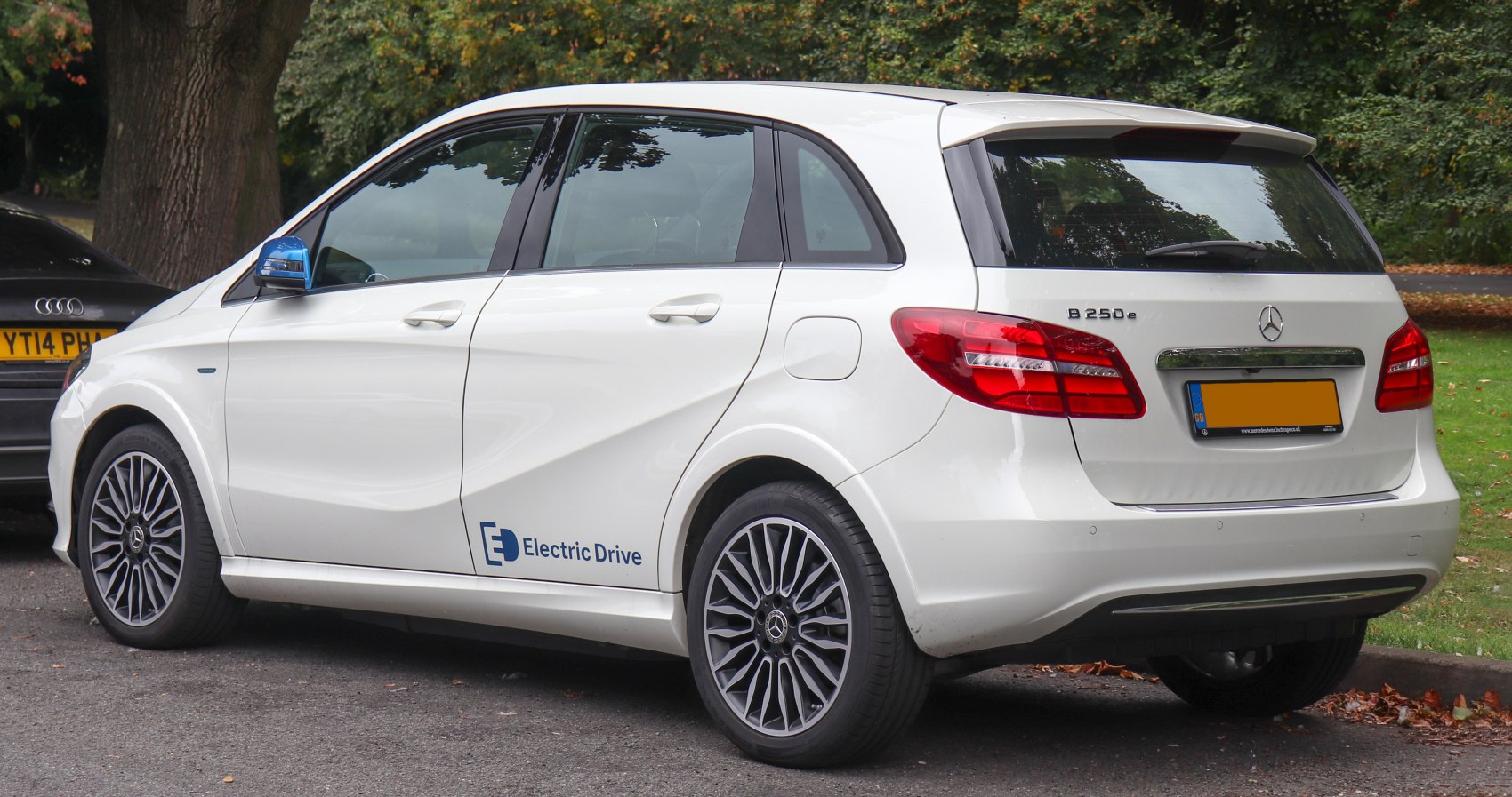 Rear side profile of white electric hatchback with alloy wheels and Electric Drive badge