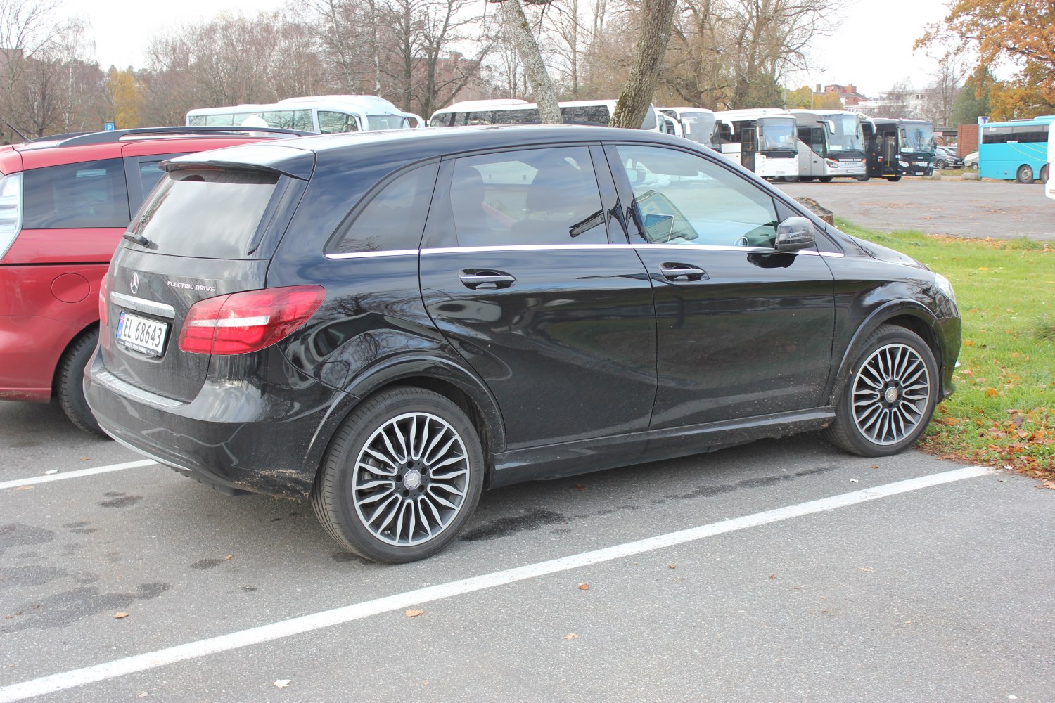 Black electric compact hatchback with modern multi-spoke alloy wheels