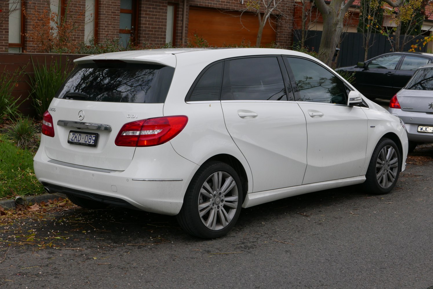 Rear and side view of white hatchback with distinctive tail lights