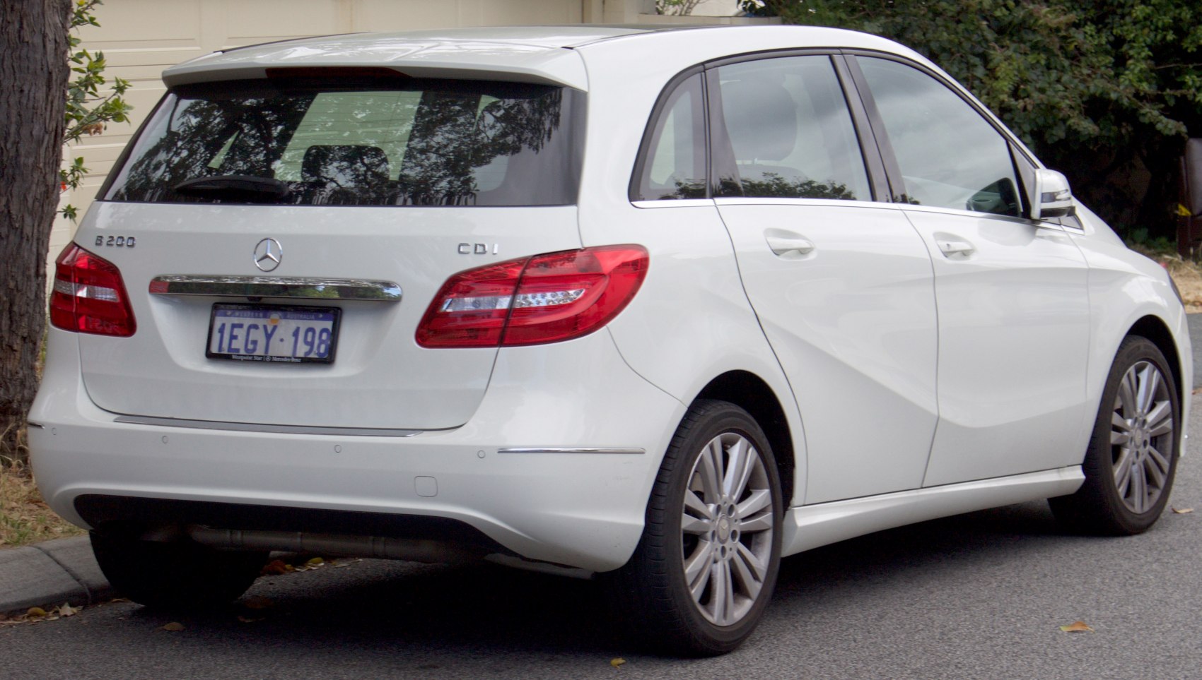 Rear and side view of a white hatchback with distinctive taillights.