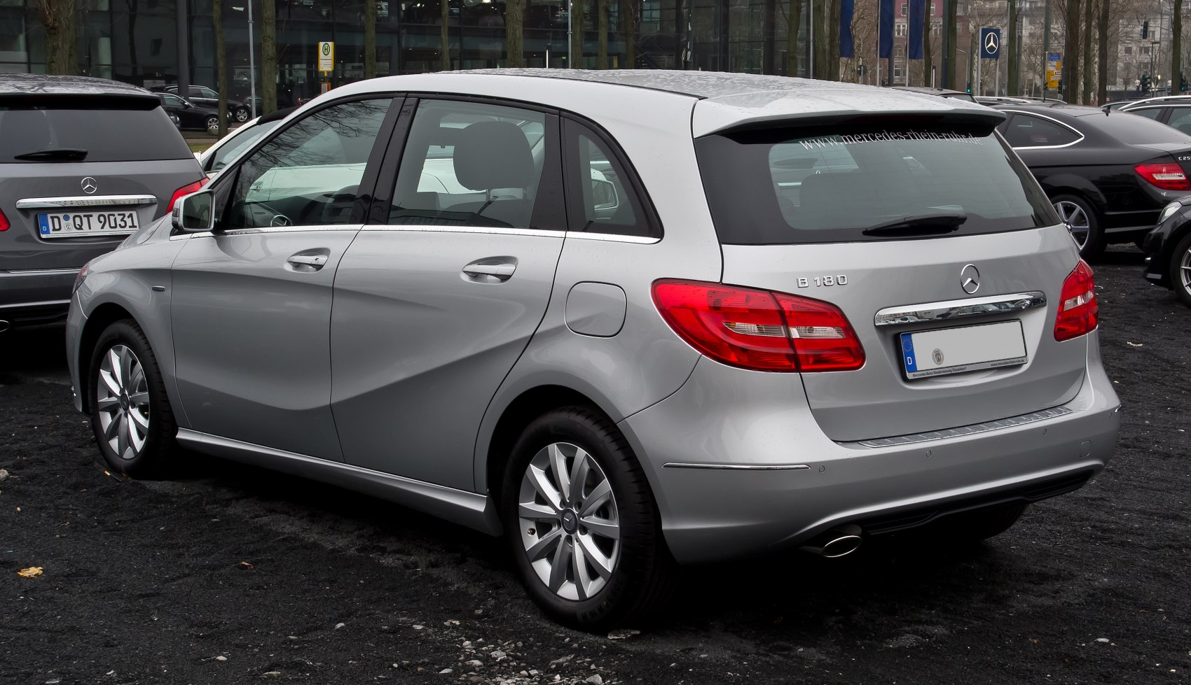 Rear side profile of a silver hatchback with sleek taillights and alloy wheels.