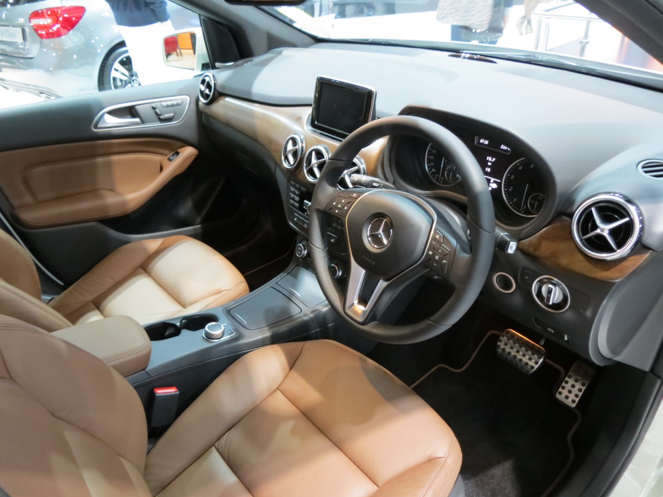 Luxurious tan leather seats with modern dashboard and multifunction steering wheel