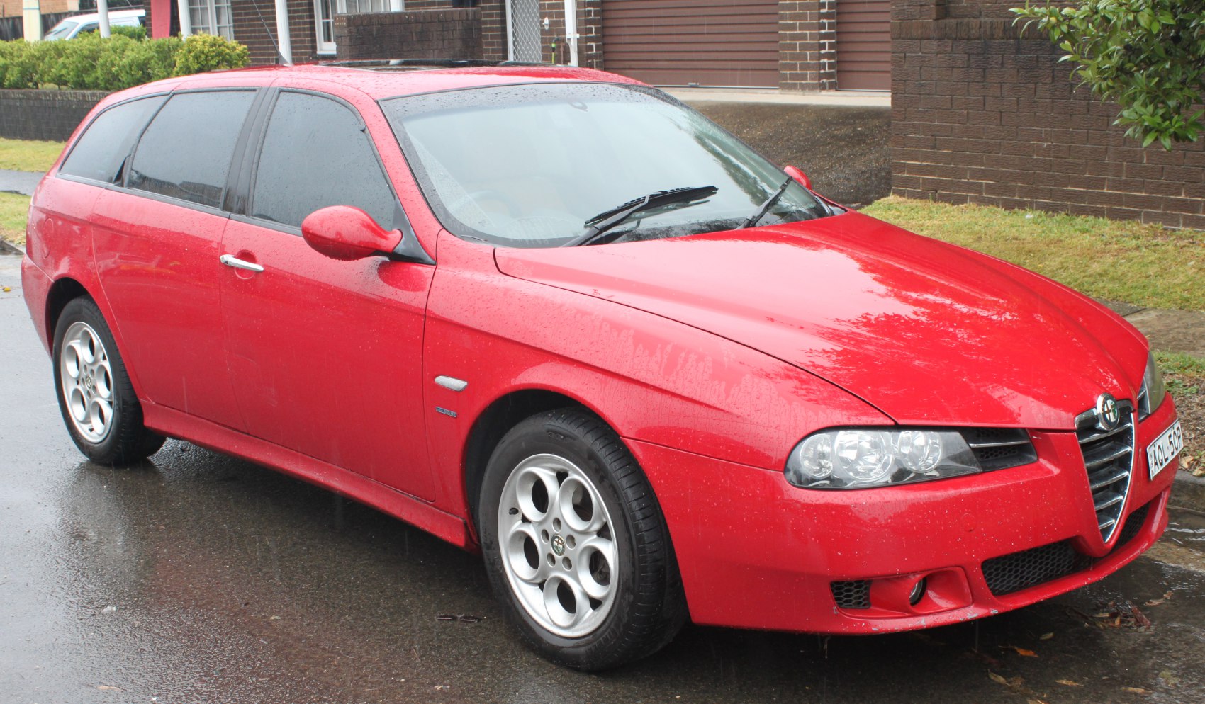 Red sport wagon with distinctive front grille and alloy wheels