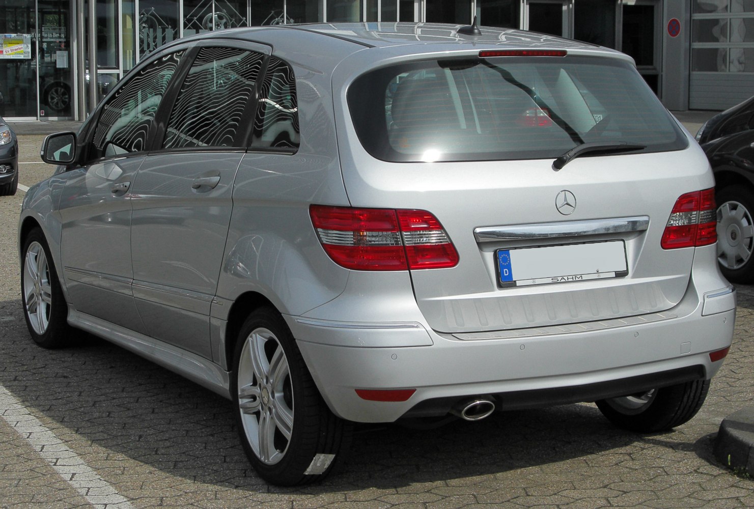 Rear and side profile of a silver hatchback with alloy wheels and distinctive tail lights