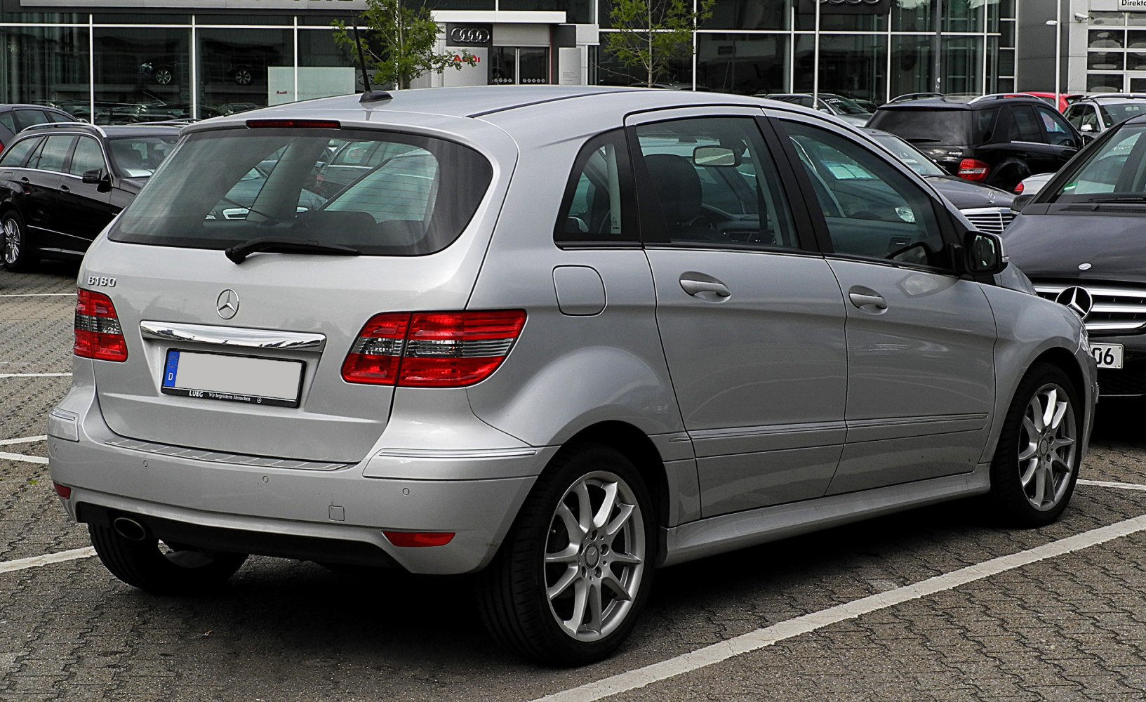Silver hatchback with rear side view showing tail lights and alloy wheels