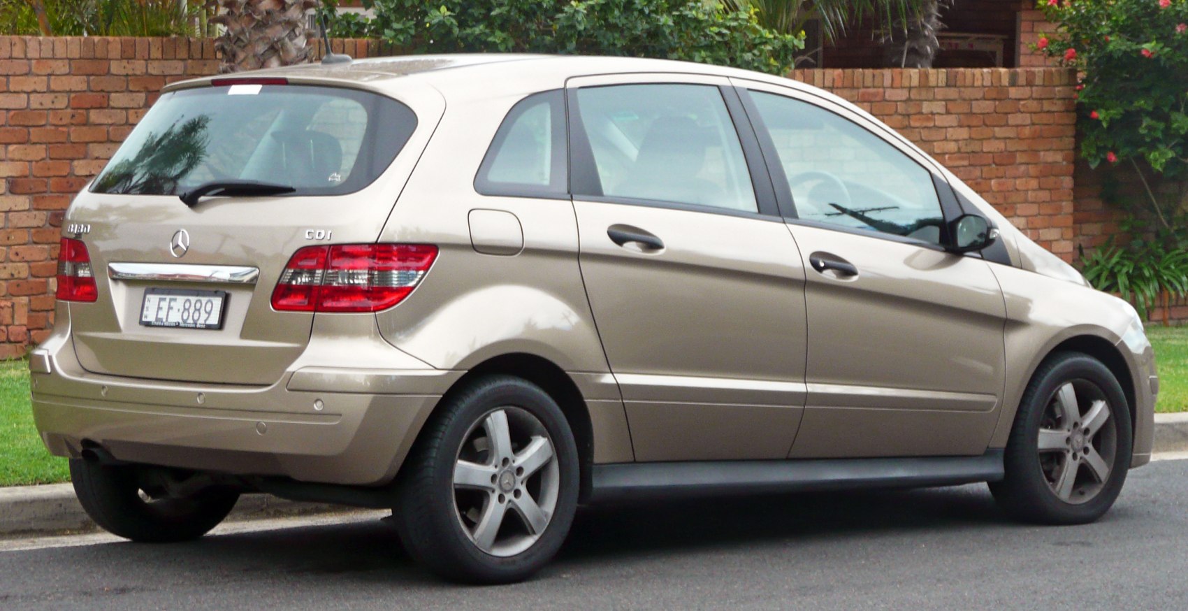 Rear side view of compact hatchback with alloy wheels and clean lines