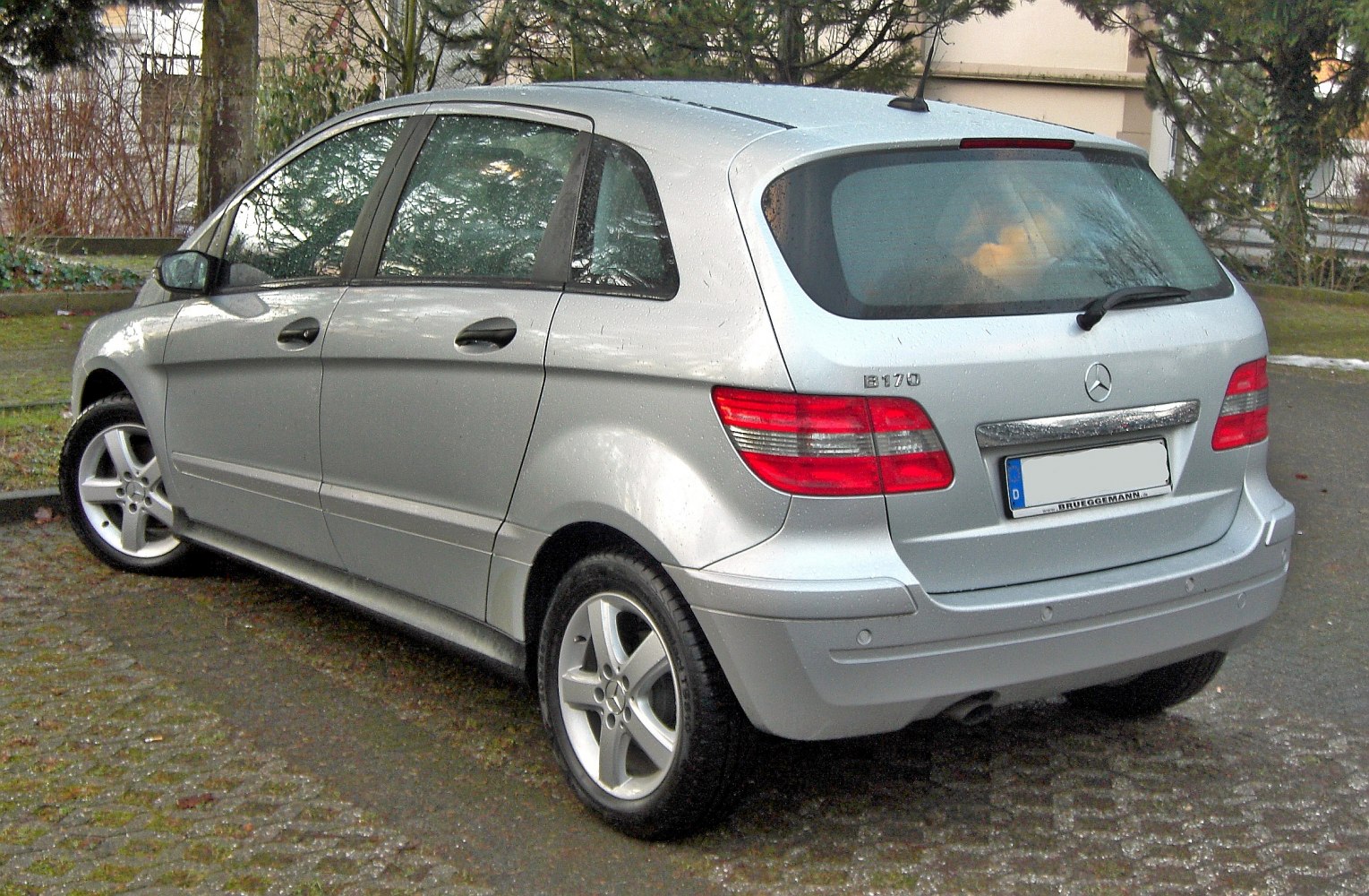 Rear side view of silver compact hatchback with distinct taillights
