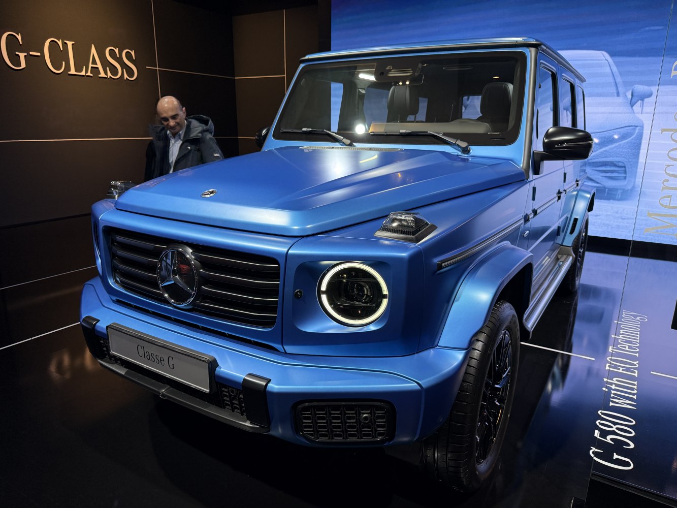 Blue SUV with circular LED headlights and bold front grille