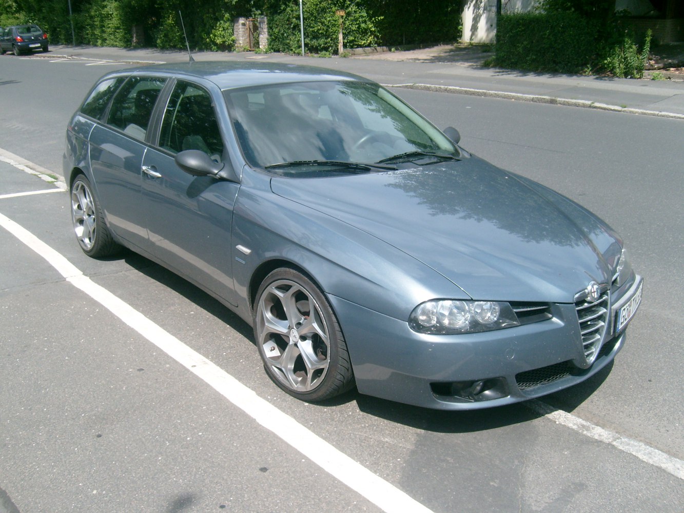 Front side view of a sport wagon with distinctive grille and alloy wheels