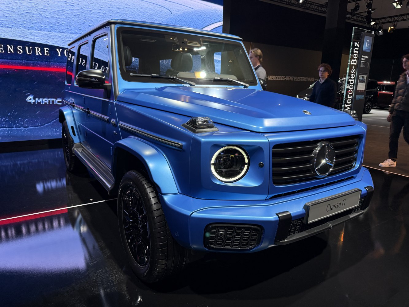 Blue matte finish SUV with round LED headlights and black accents.