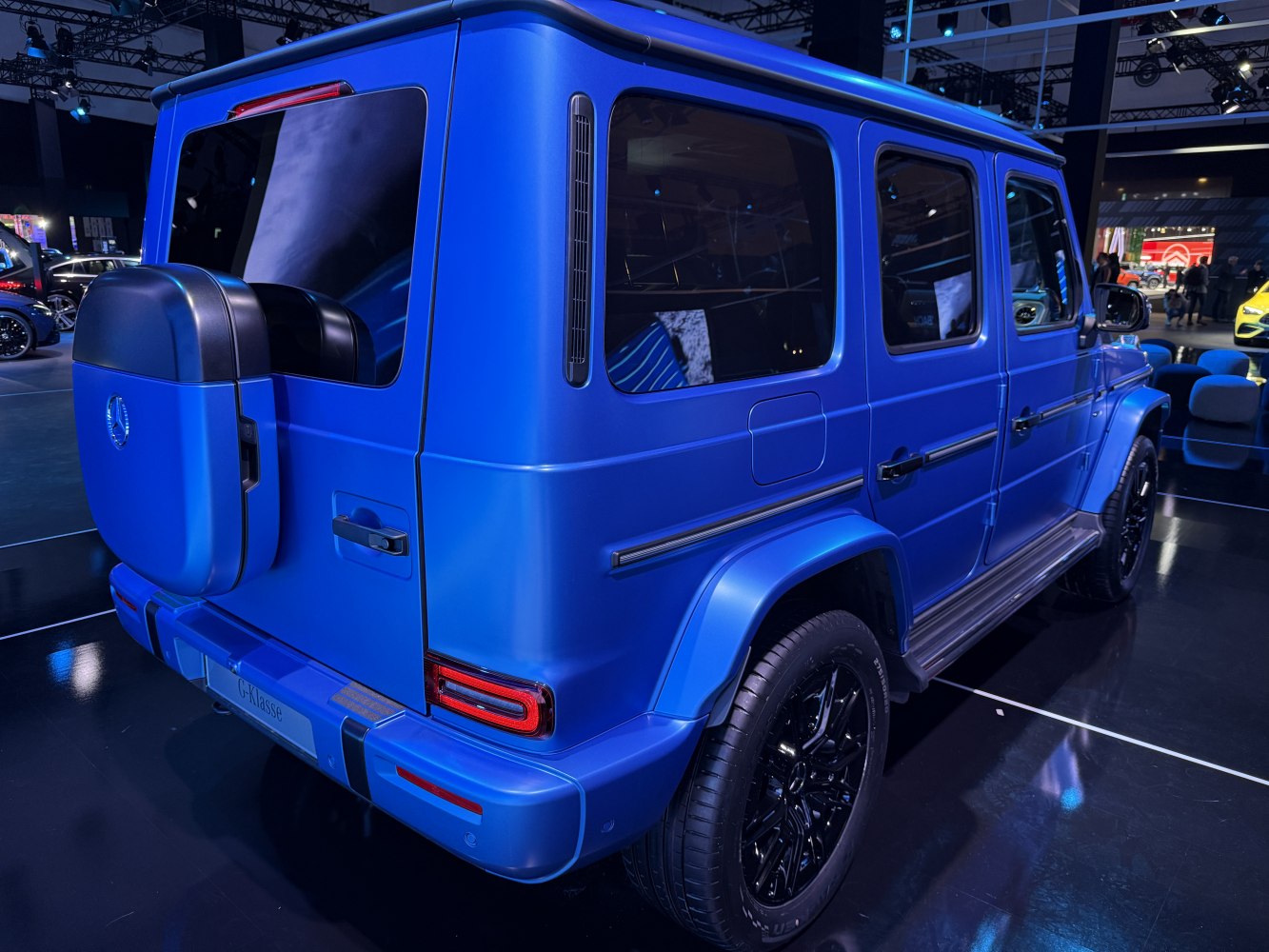 Rear-side view of extended SUV with spare tire and tinted windows