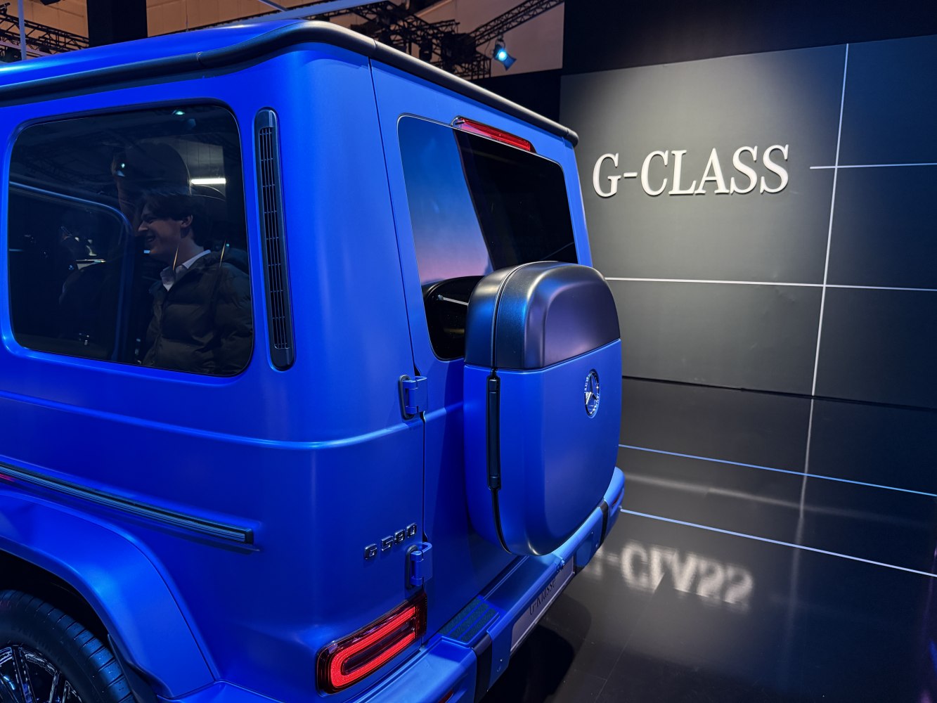 Rear view of matte blue SUV with rear-mounted spare tire and LED taillights