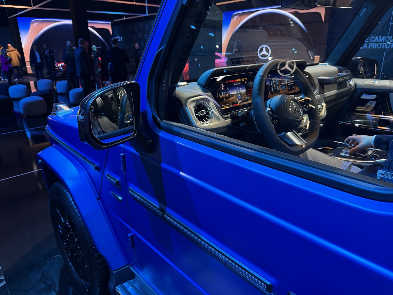 Blue SUV side view with modern digital interior and dashboard