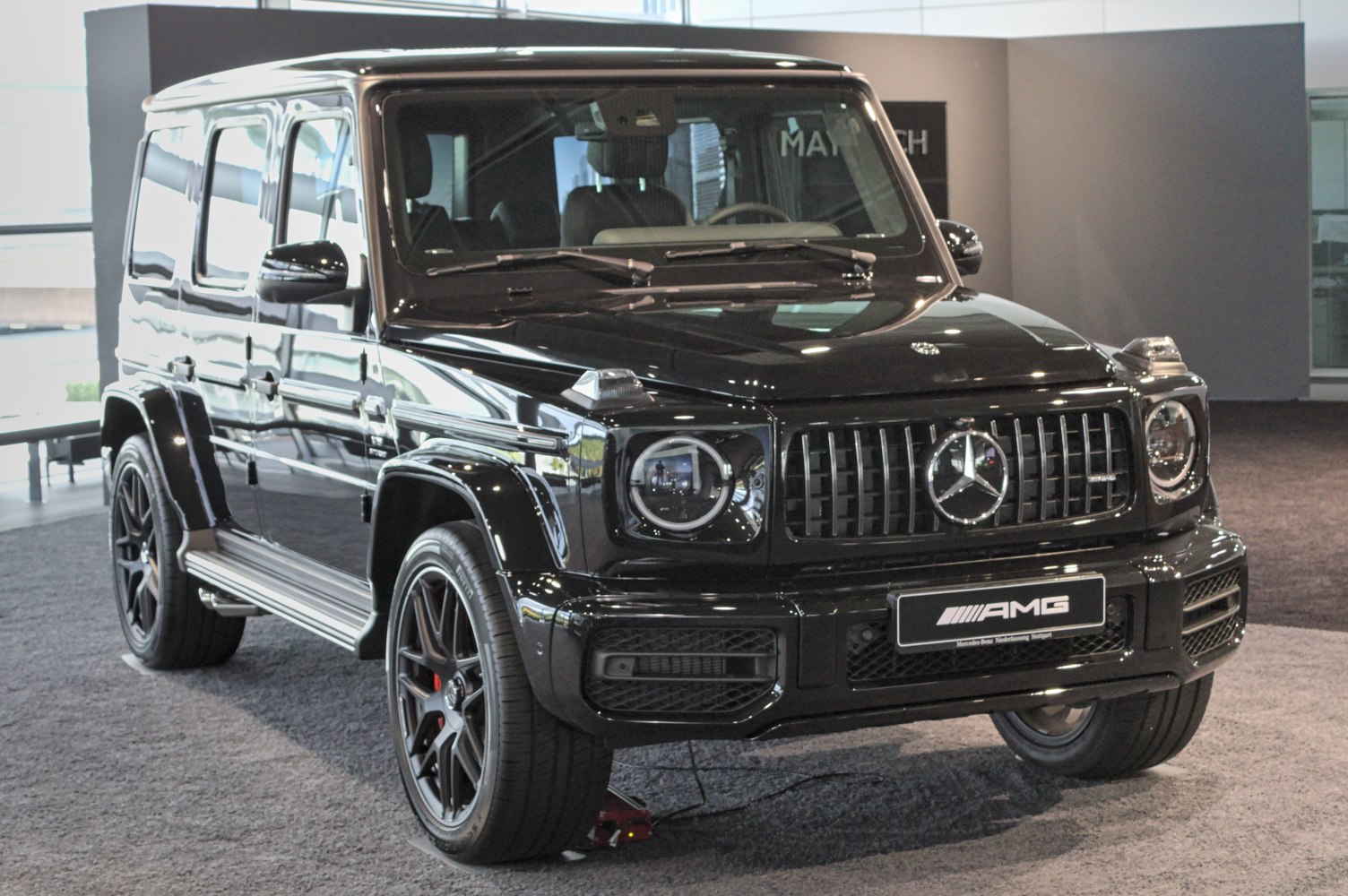 Front view of black luxury SUV with AMG grille and LED headlights