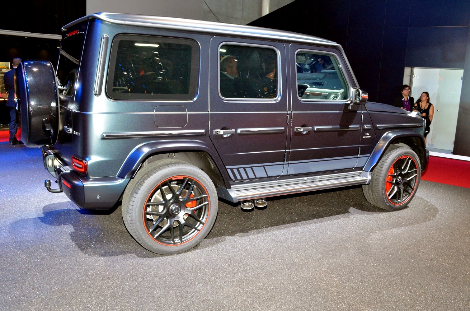 Side profile with custom black alloy wheels and side exhaust pipes