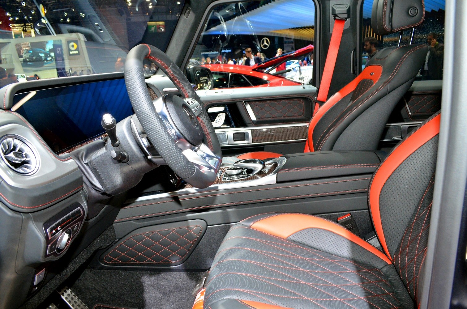 Luxury black and red leather interior with diamond stitching and advanced infotainment.