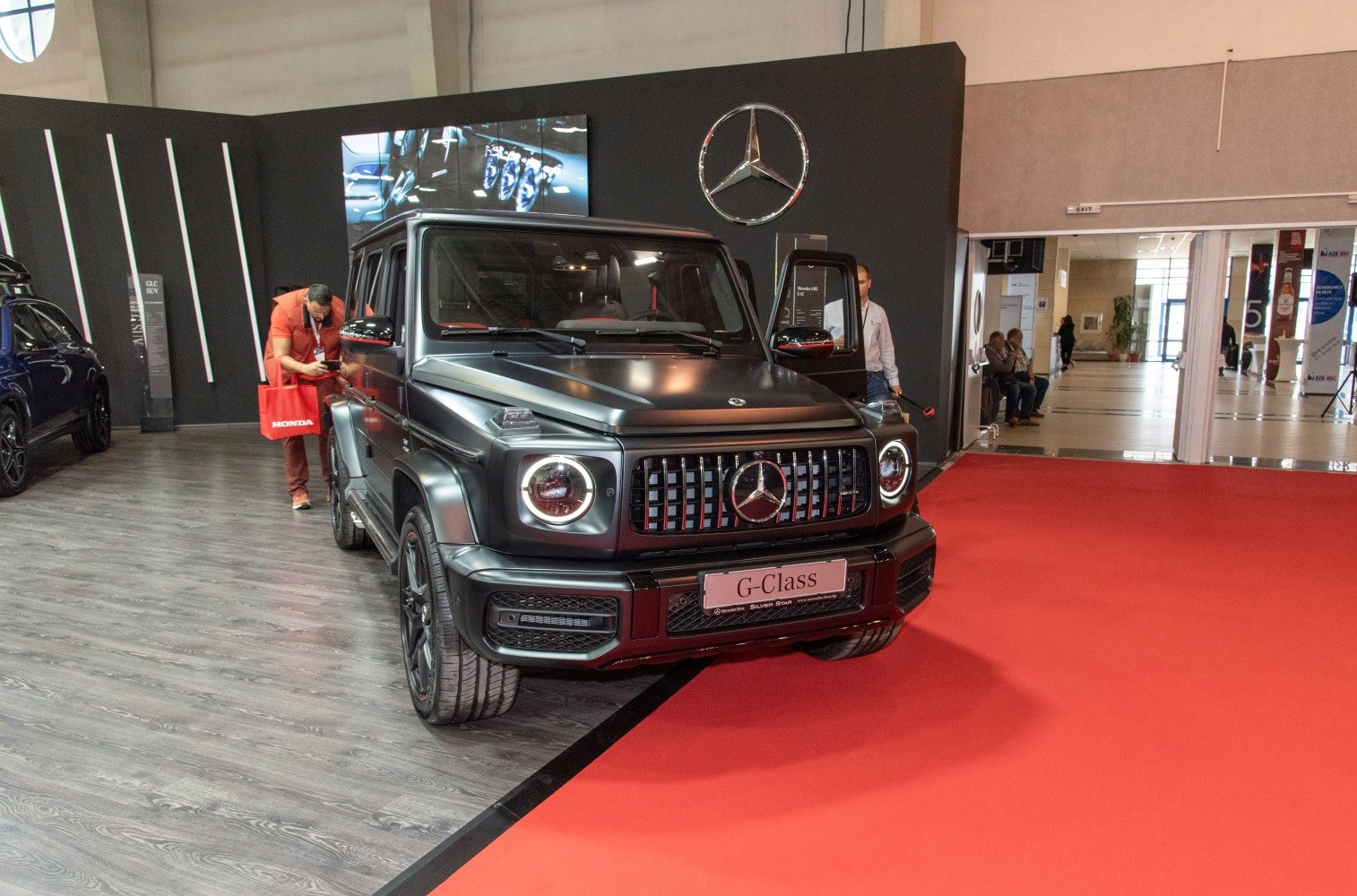 Matte black SUV front with round LED headlights and vertical grille bars