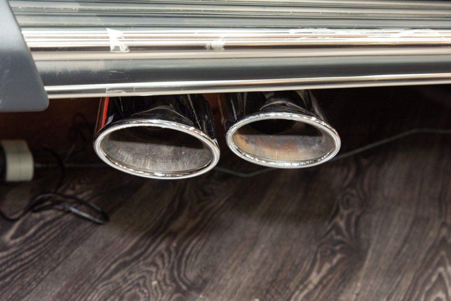 Polished chrome dual exhaust tips on vehicle rear