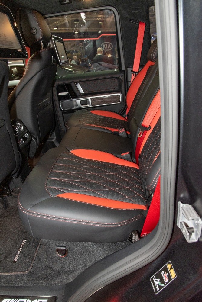 Premium black and red leather rear seats with detailed stitching.