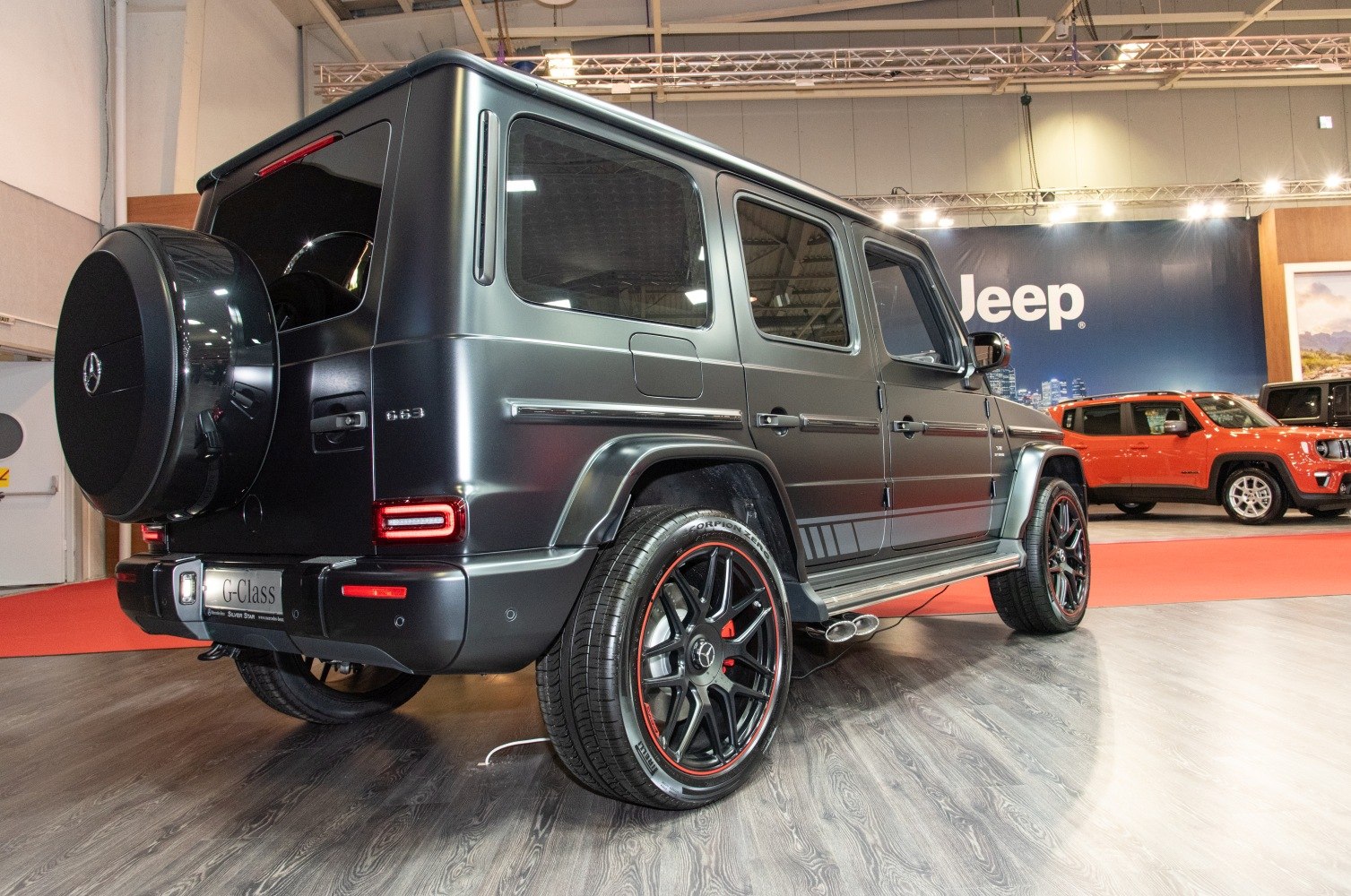 Rear side view with spare tire cover and black rims