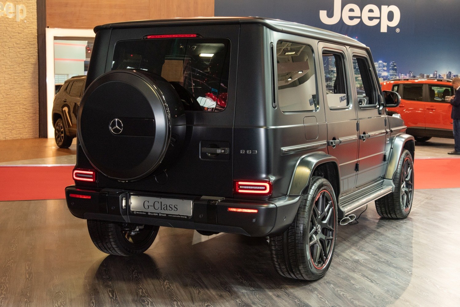 Matte black rear of luxury SUV with spare wheel cover and LED taillights.