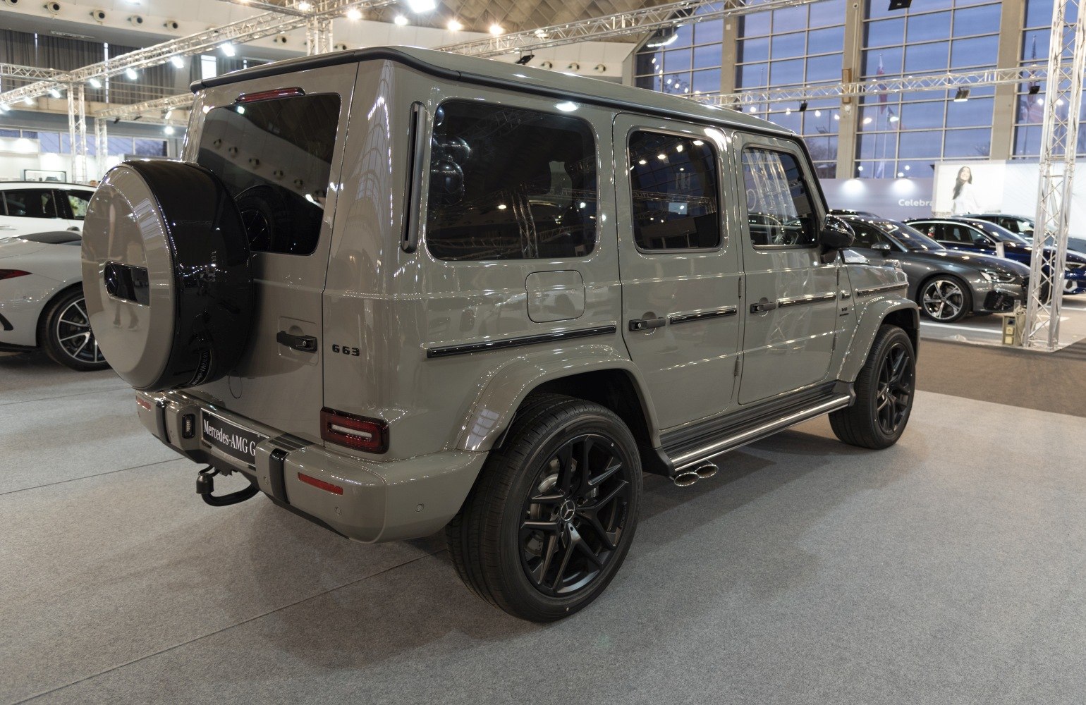 Rear and side profile of luxury SUV with spare wheel cover and side exhaust pipes