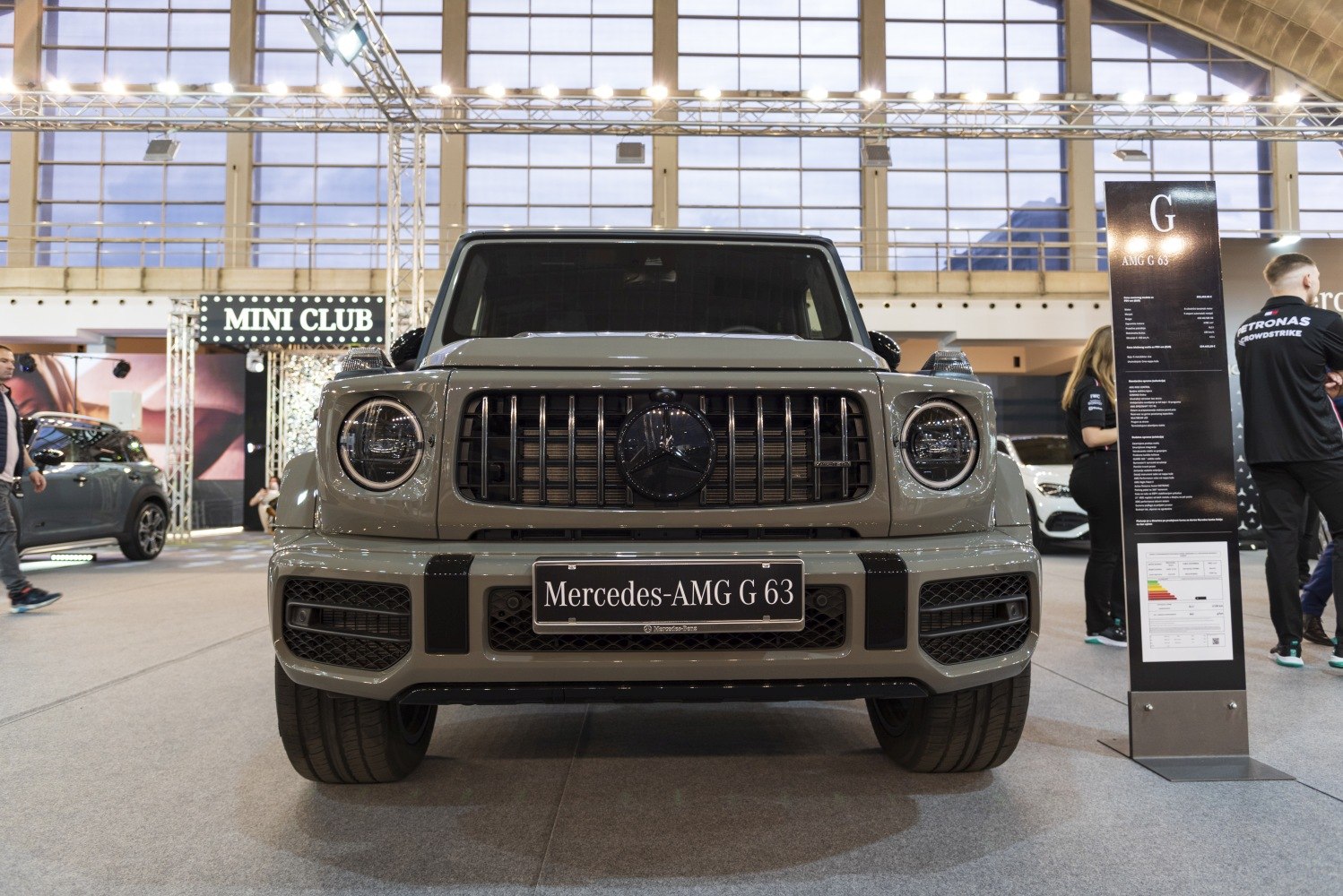 Front view of a luxury SUV with round headlights and vertical-bar grille
