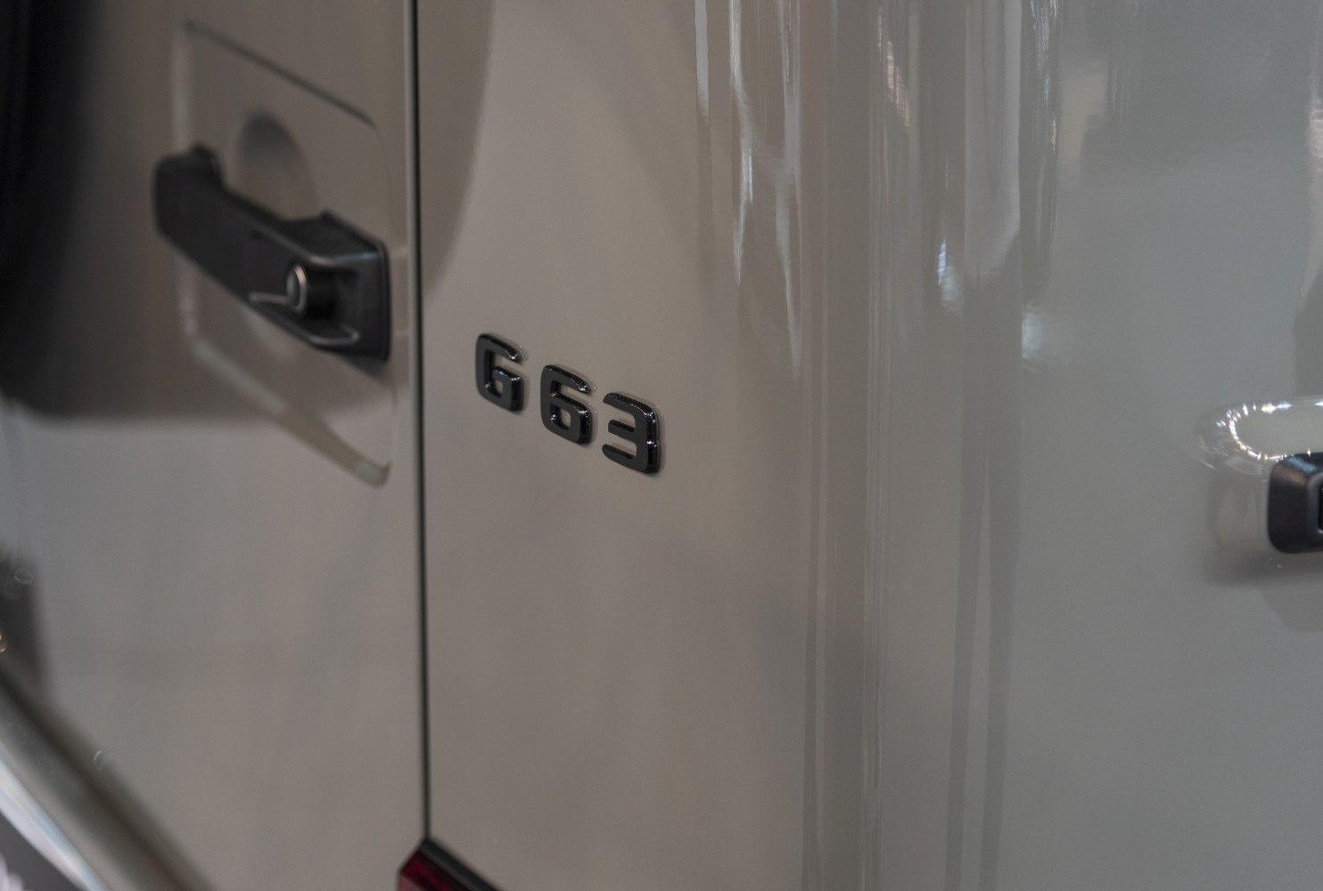 Close-up of G63 badge and door handle on vehicle side