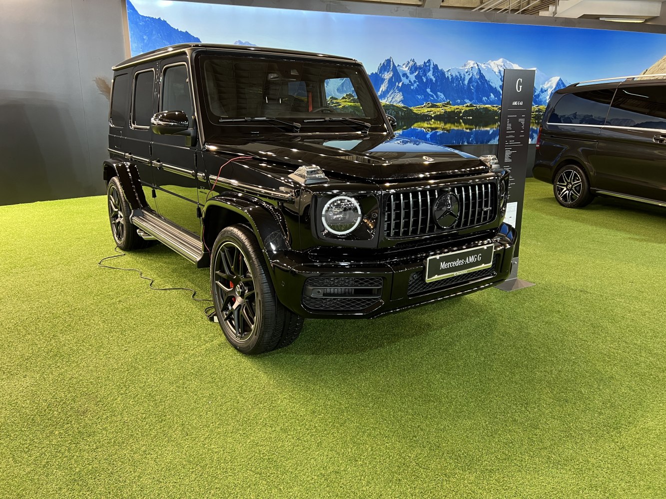 Luxury SUV with AMG grille, round headlights, sporty wheels