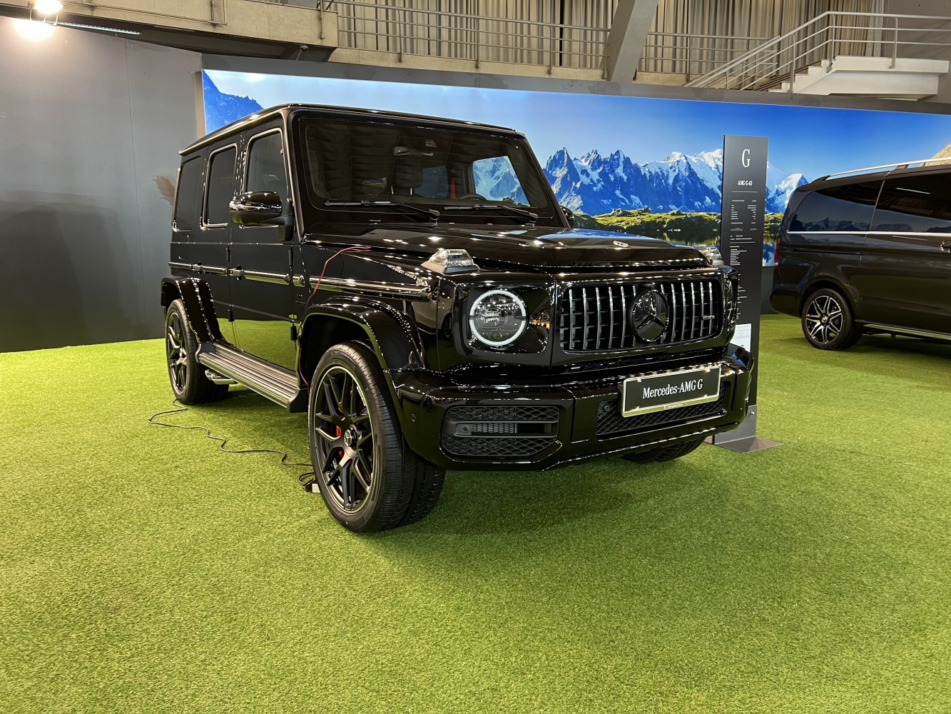 Black SUV with round headlights, vertical grille, and large wheels