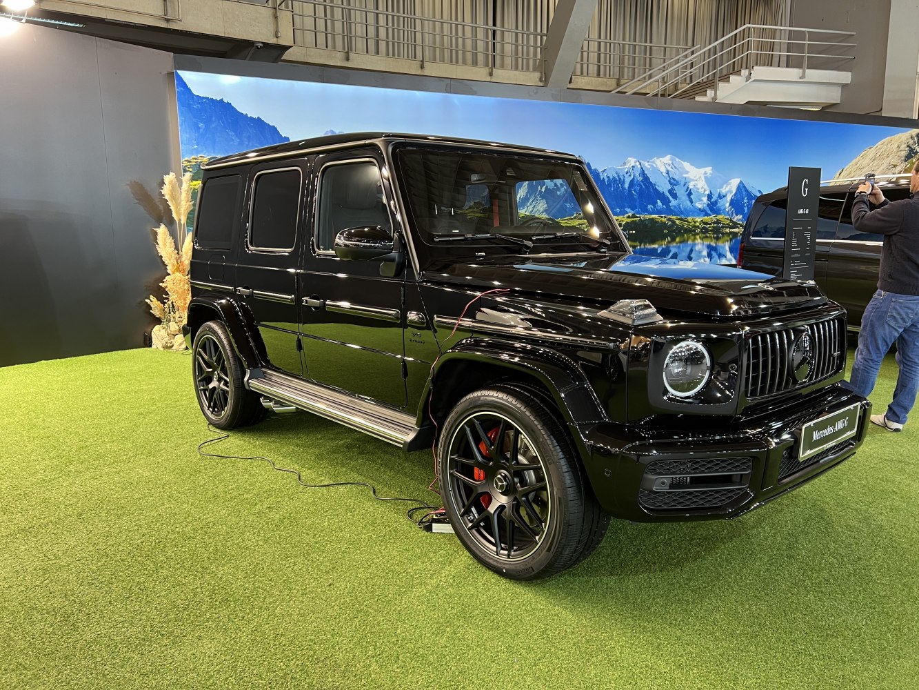 Black luxury SUV with round LED headlights and AMG wheels.