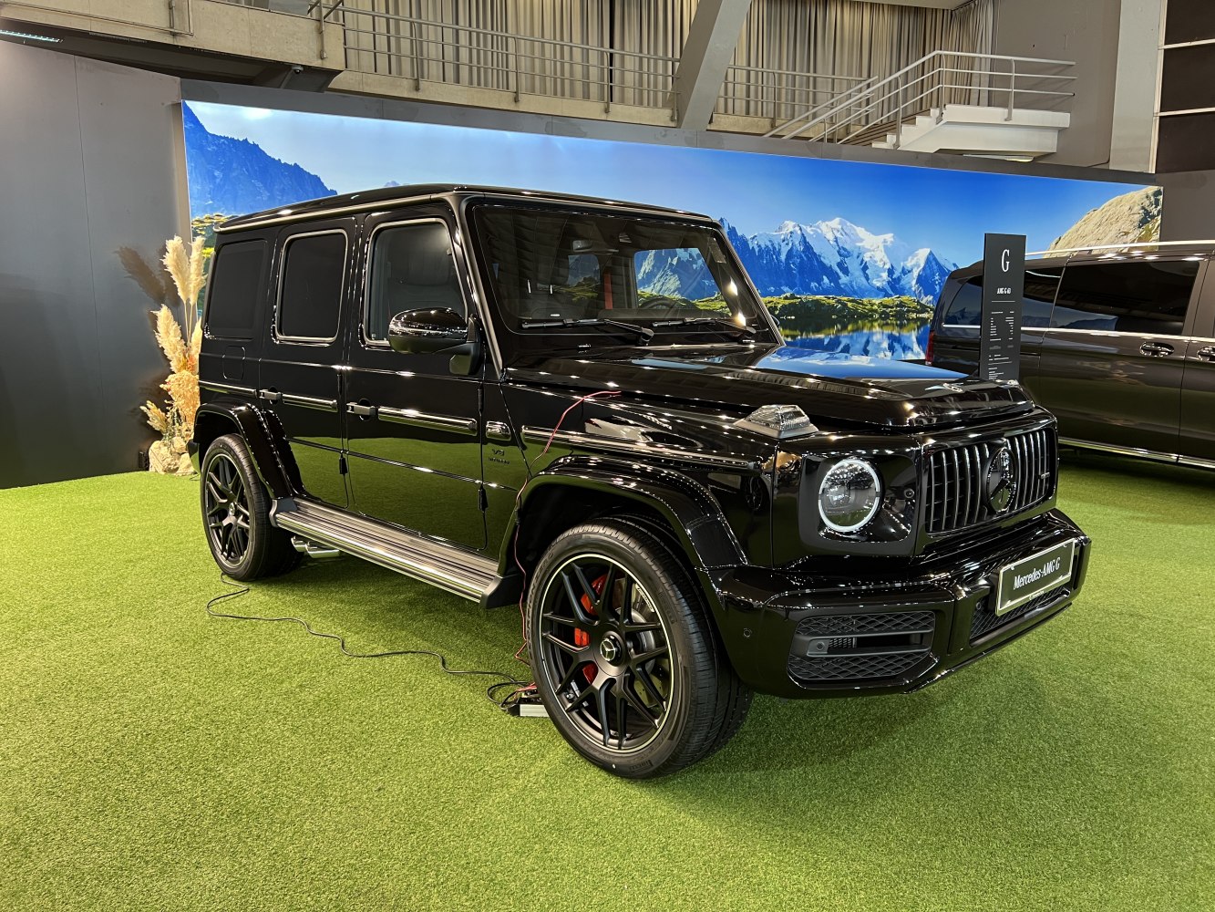 Black luxury SUV with modern design, AMG wheels, side steps, front and side profile