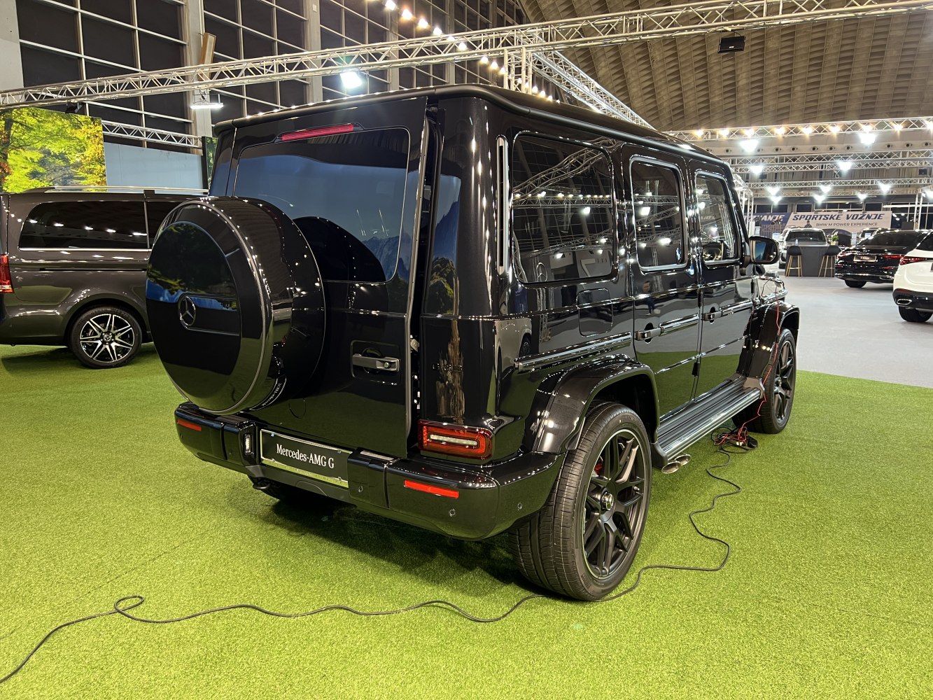 Black SUV rear view with spare wheel and side profile