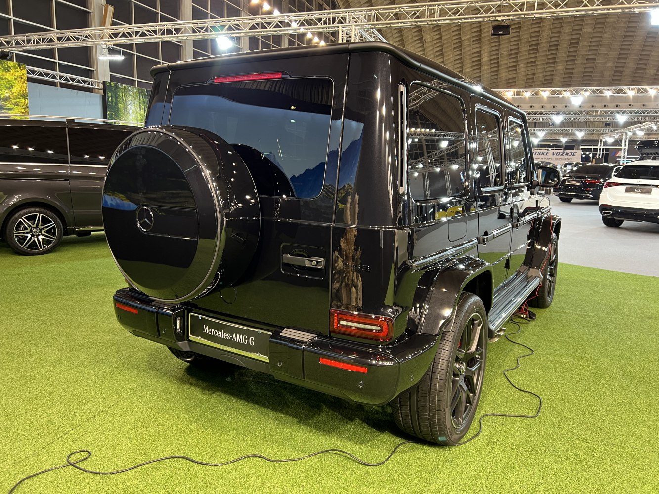 Rear view of black luxury SUV with spare tire cover and LED taillights