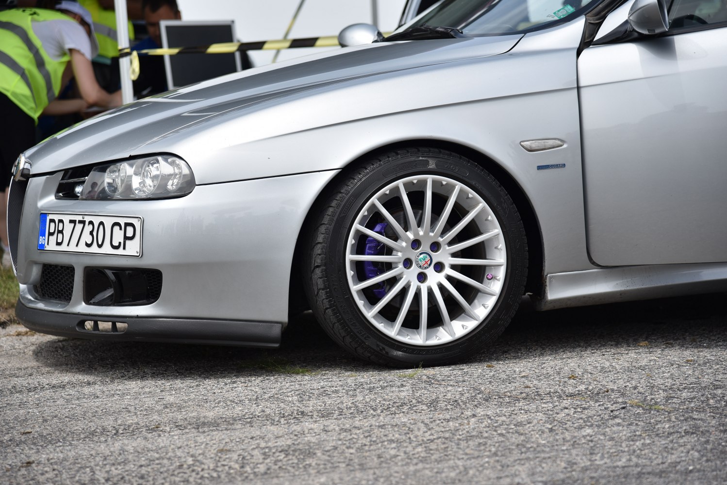 Close-up of front side with headlight and alloy wheel