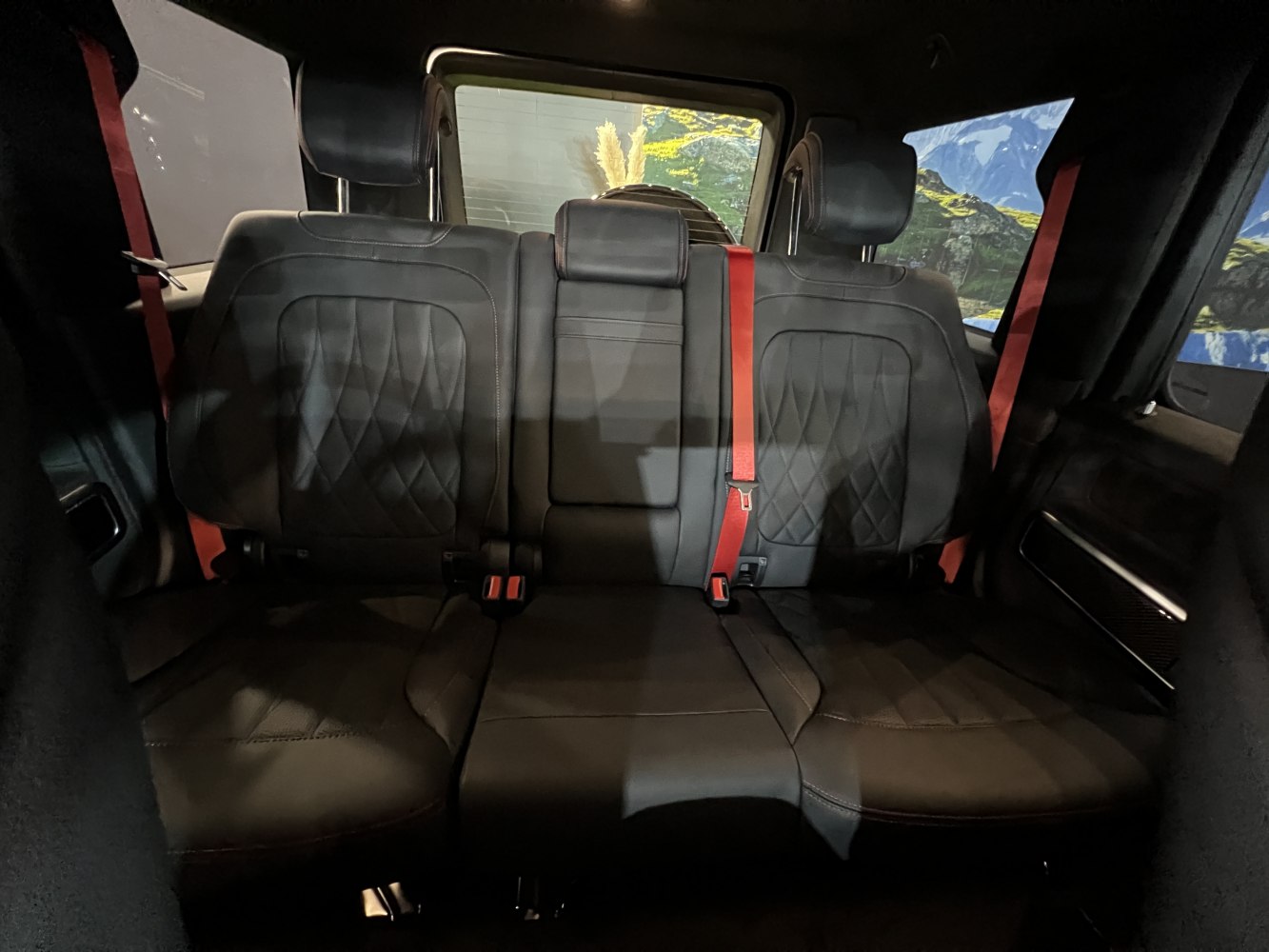 Black quilted leather rear seats with red seatbelts