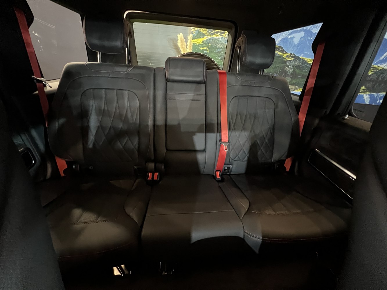 Quilted black leather rear seats with red seat belts